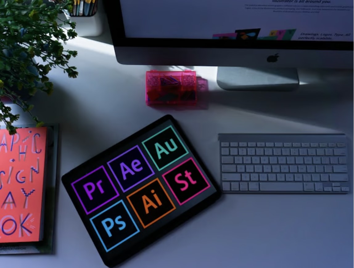 Adobe Creative Cloud apps shown on a tablet beside a keyboard